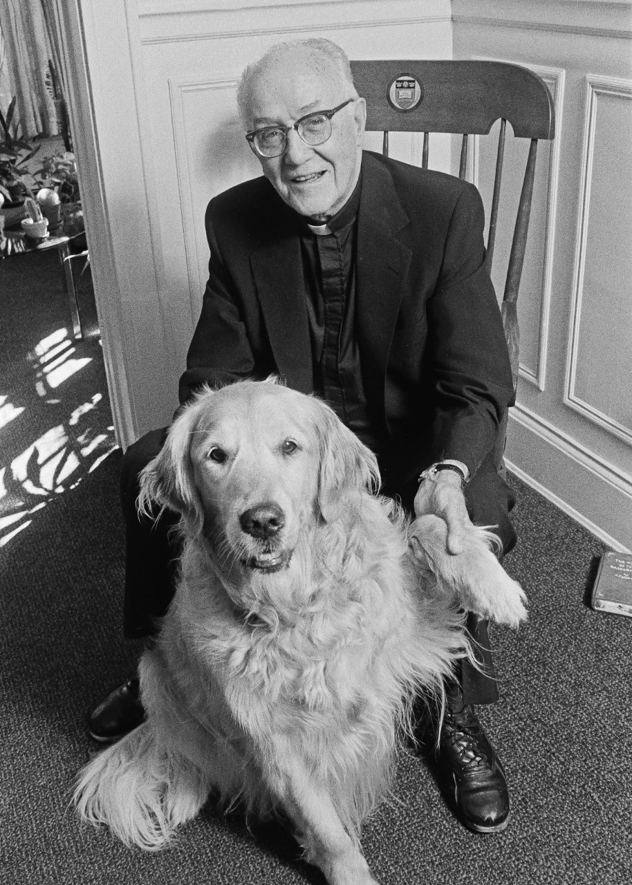 Fultonian Charles F. Donovan, S.J., seen here in later years as academic vice president of Boston College, with his golden retriever, Brandy.