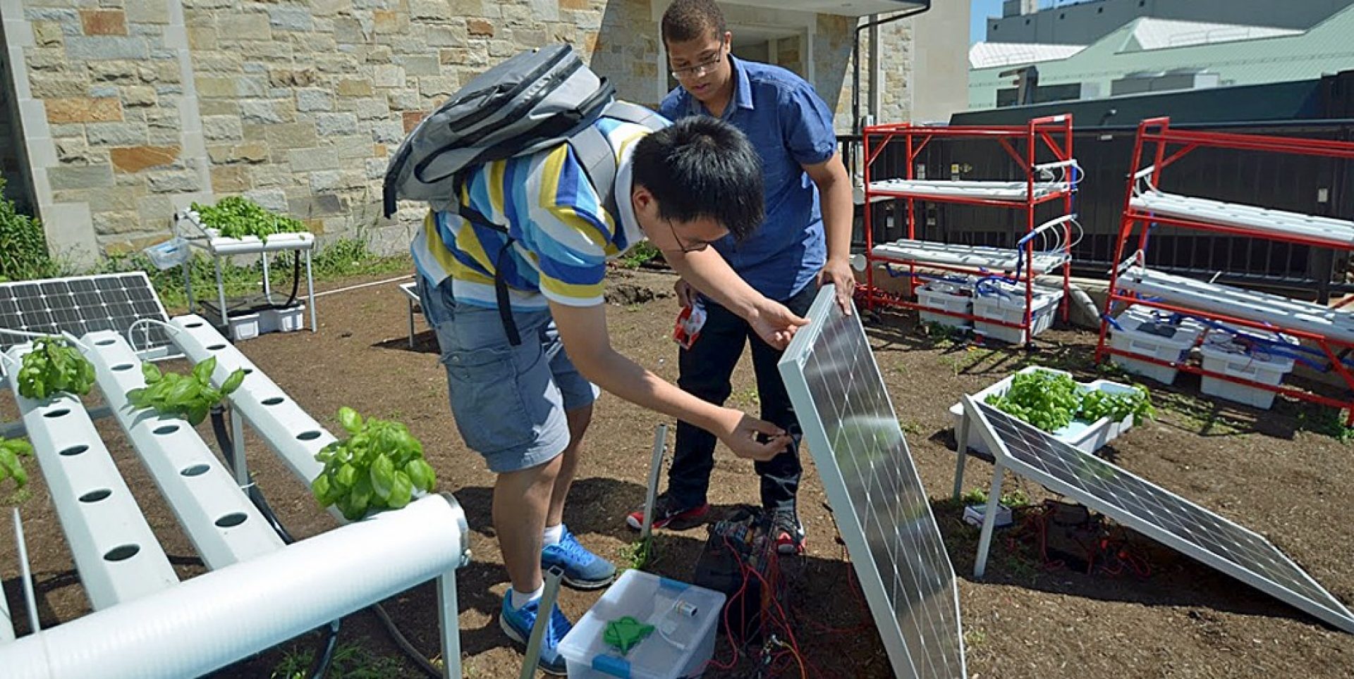 Lynn Sejour, a sophomore at the West Roxbury Education Complex, Yaderiz Mendez, and eighth grader at the James A. Hennigan K-8 School in Jamaica Plain, and Bryonia Brown, who will attend Brockton High School this fall, prepare a presentation for a project they completed during a two-week STEM workshop held on campus in July.