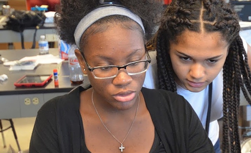 Lynn Sejour, a sophomore at the West Roxbury Education Complex, Yaderiz Mendez, an eighth grader at the James A. Hennigan K-8 School in Jamaica Plain, prepare a presentation for a project they completed during a two-week STEM workshop held on campus in July. Lynn Sejour, a sophomore at the West Roxbury Education Complex, Yaderiz Mendez, an eighth grader at the James A. Hennigan K-8 School in Jamaica Plain, prepare a presentation for a project they completed during a two-week STEM workshop held on campus in July.