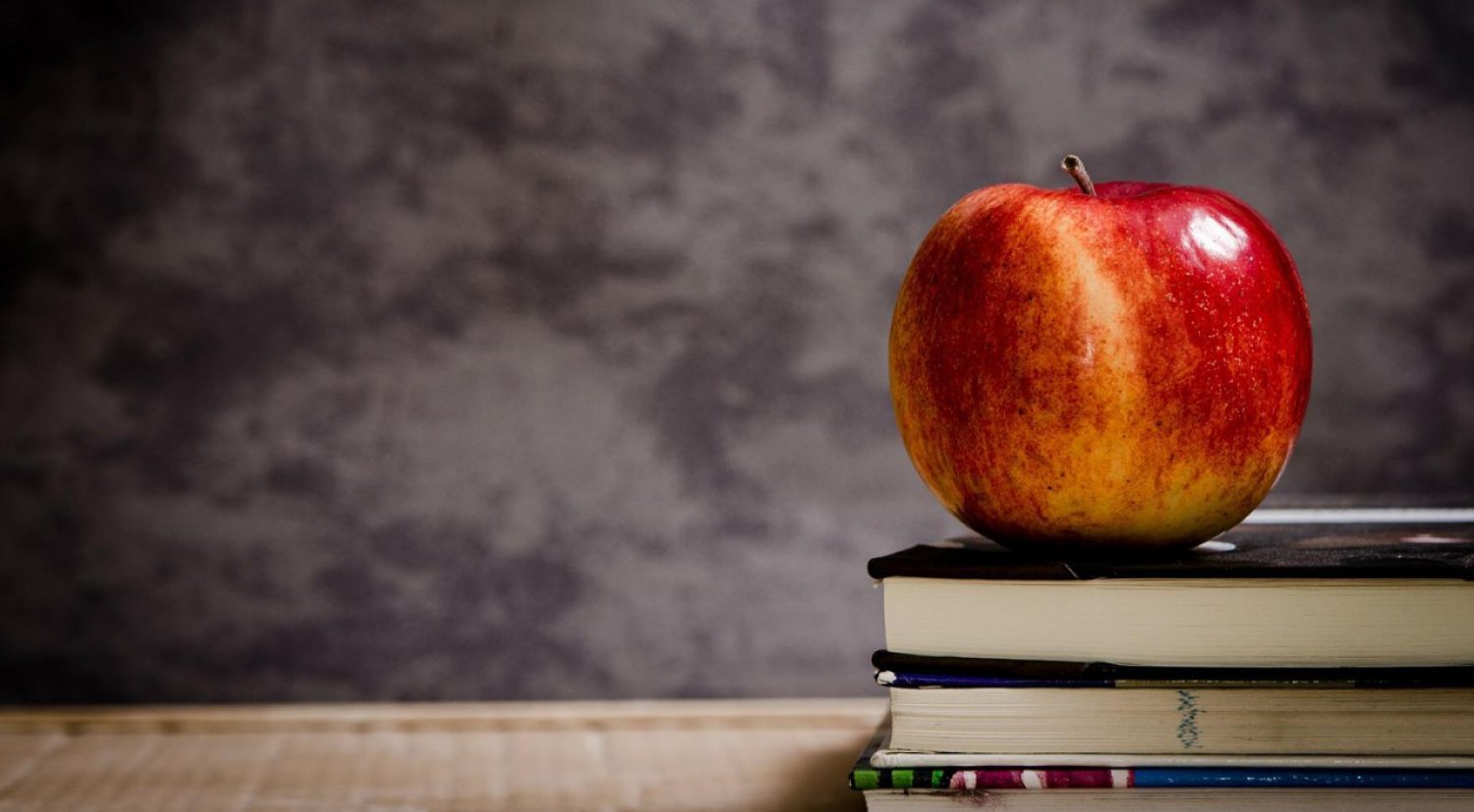 an apple on a stack of books