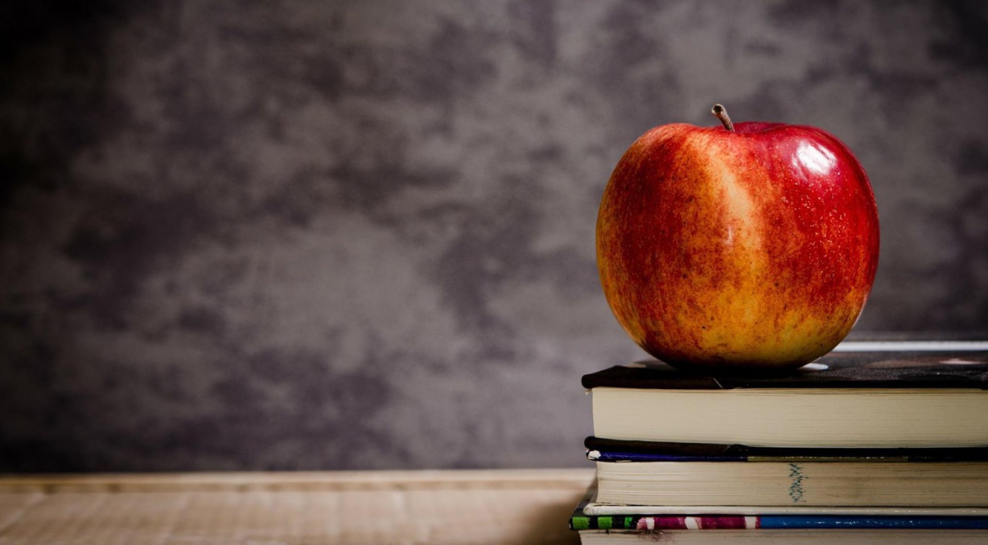 an apple on a stack of books