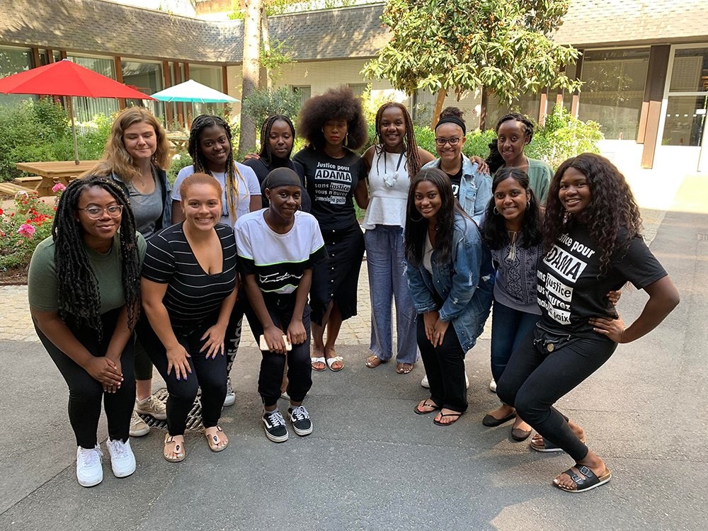 A group of students posing for a photo with Assa Traoré