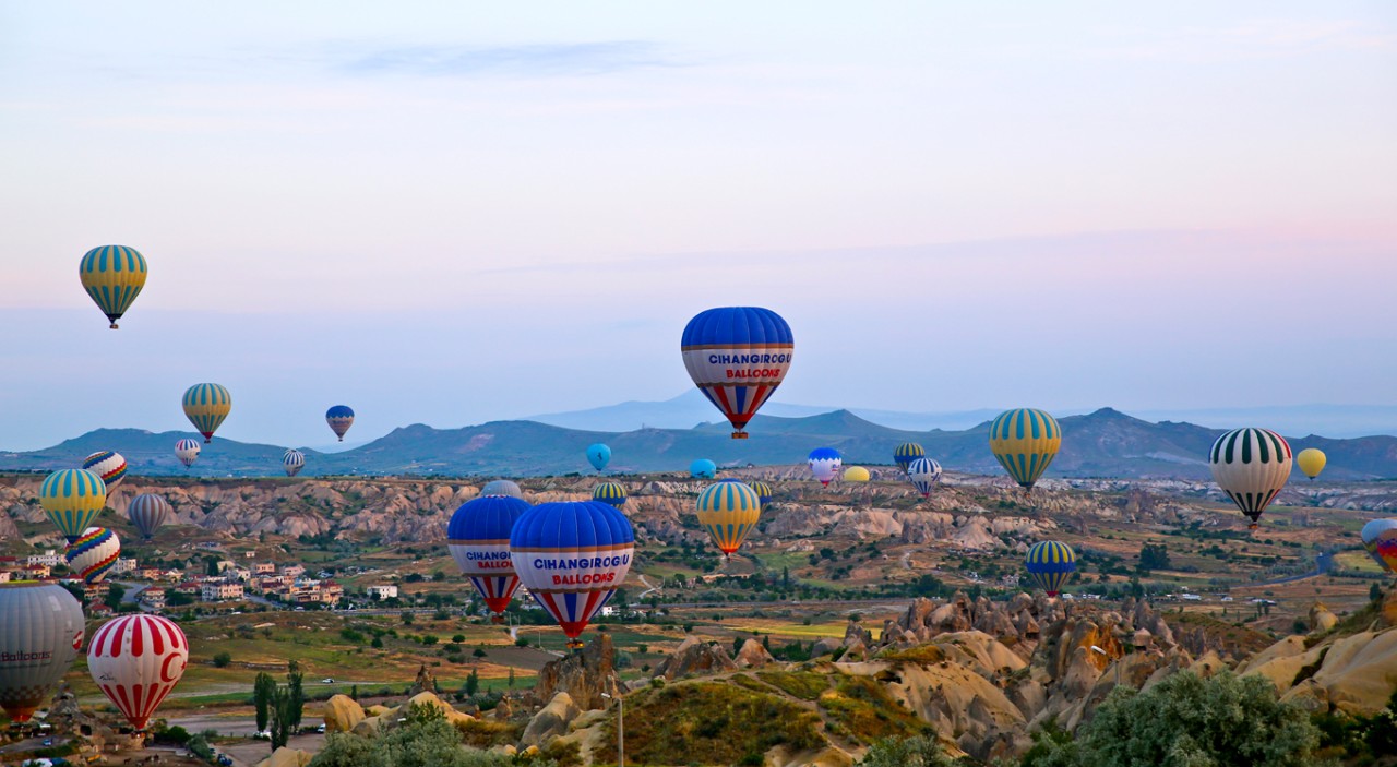 Hot air balloons take flight at dawn above Cappadocia, in central Turkey