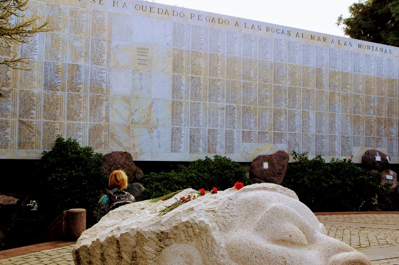 Associate Professor of History Franziska Seraphim sits in front of a memorial in Santiago's General Cemetery to the victims of the Pinochet dictatorship that ruled Chile between 1973 and 1990.