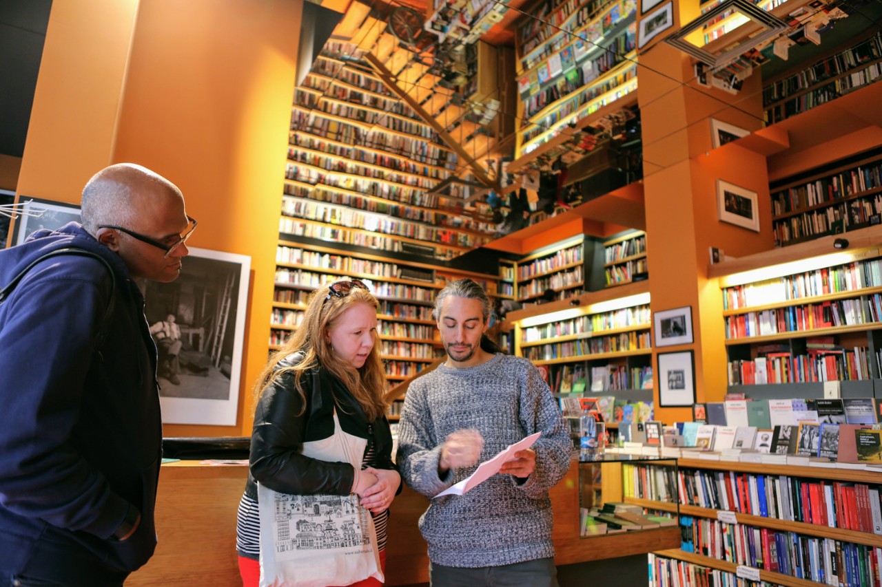 Associate Professor of the Practice of English and poet Alison Adair talks with Chilean poet Jorge Rosemary at the Ulises bookstore in Santiago. Looking on is Associate Professor of History Martin Summers. Associate Professor of the Practice of English and poet Alison Adair talks with Chilean poet Jorge Rosemary at the Ulises bookstore in Santiago. Looking on is Associate Professor of History Martin Summers.