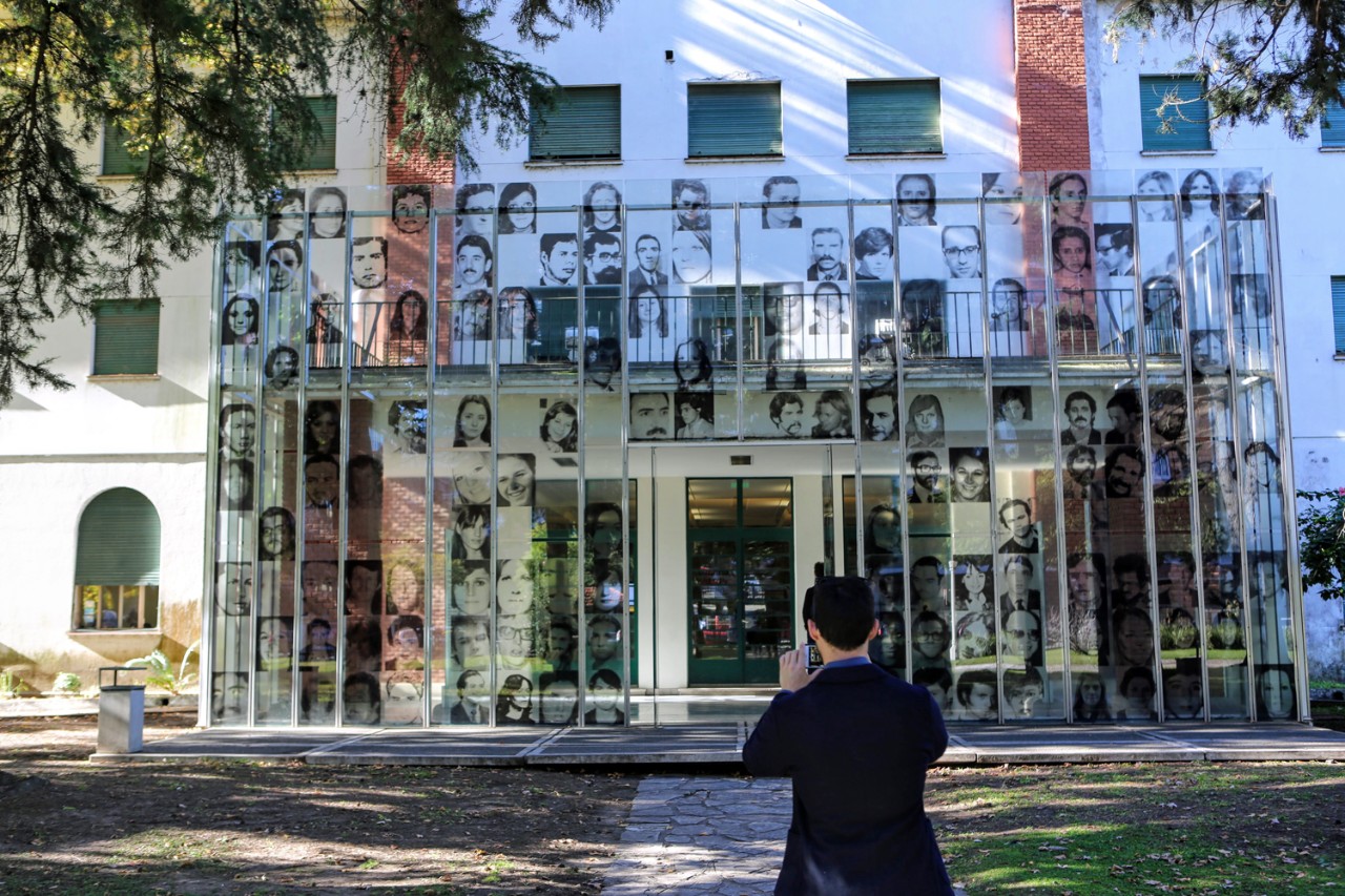 Assistant Professor of the Practice of Philosophy David Storey takes a picture of the entrance to a memorial museum located in buildings that once housed a detention and torture center on the site of Argentina's former naval academy near downtown Buenos Aires.