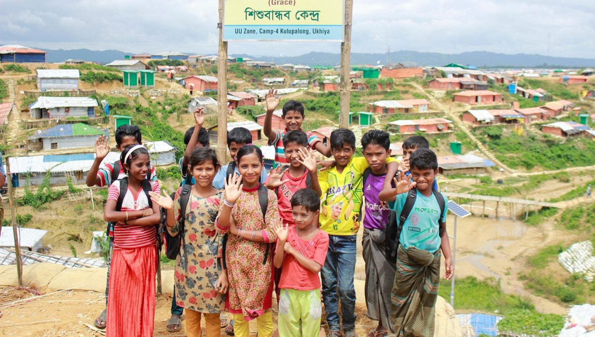 A group of children waving