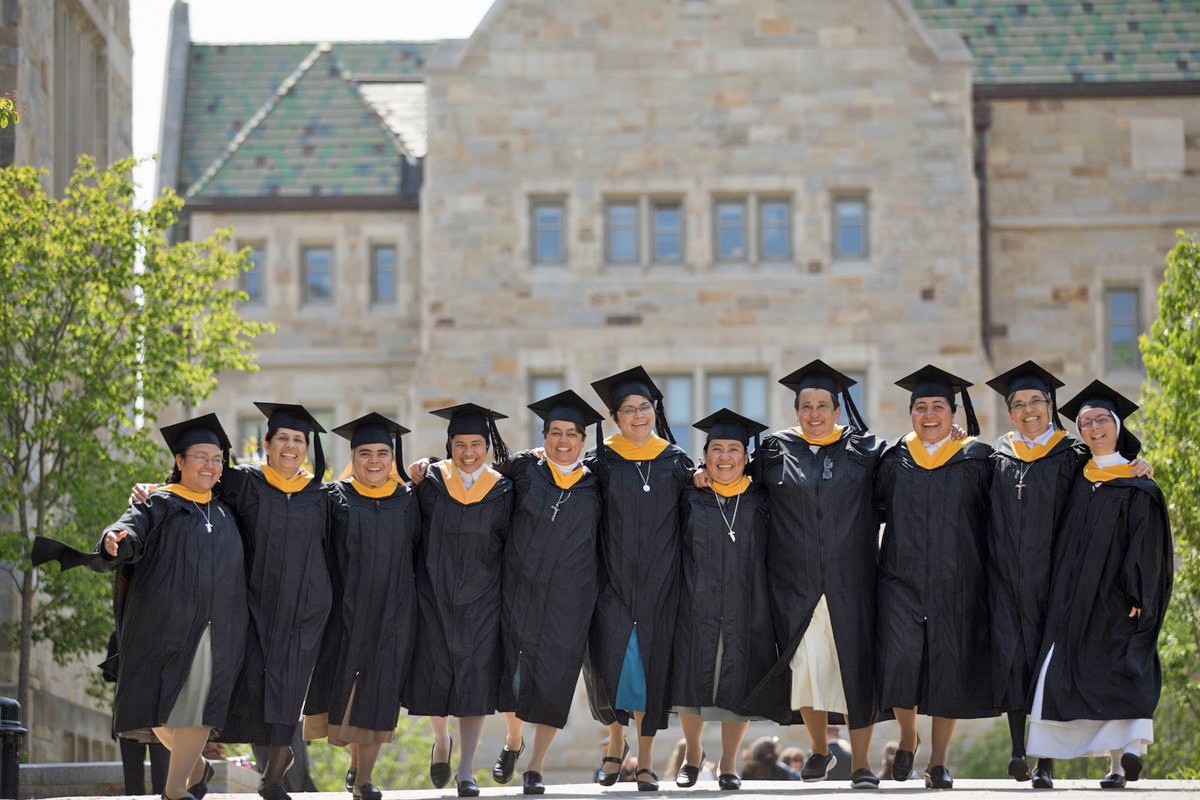 Latin American sisters in cap and gown