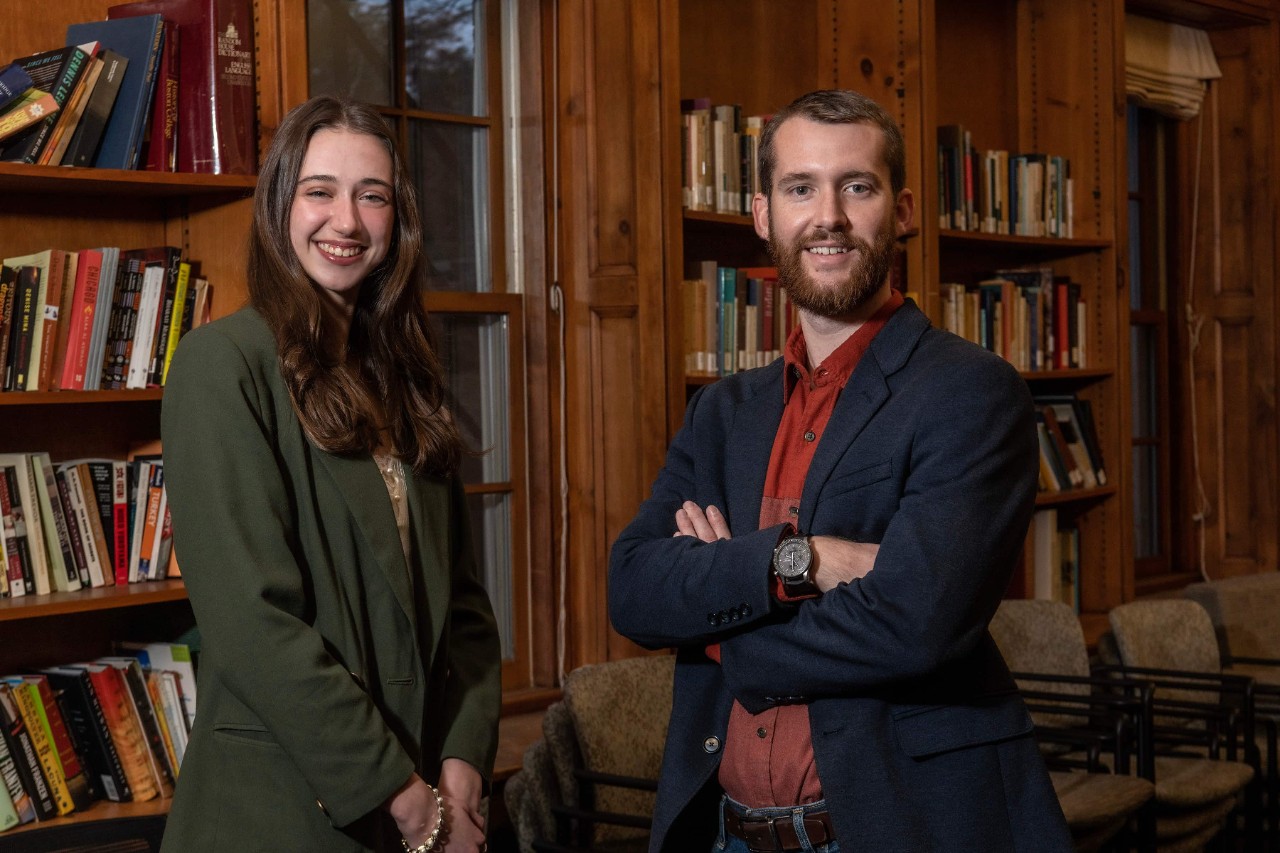 Faith Drescher and Tyler Parker in a library