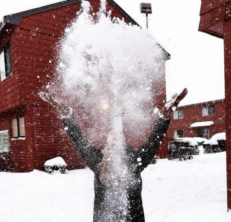student throwing snow in the mods