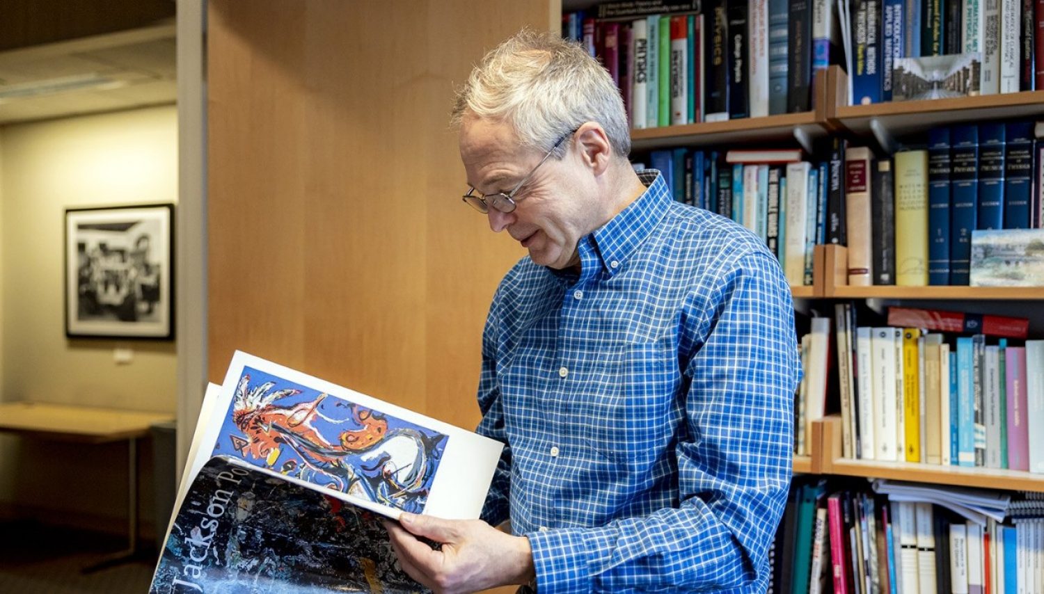 Andrzej Herczynski holding a booklet
