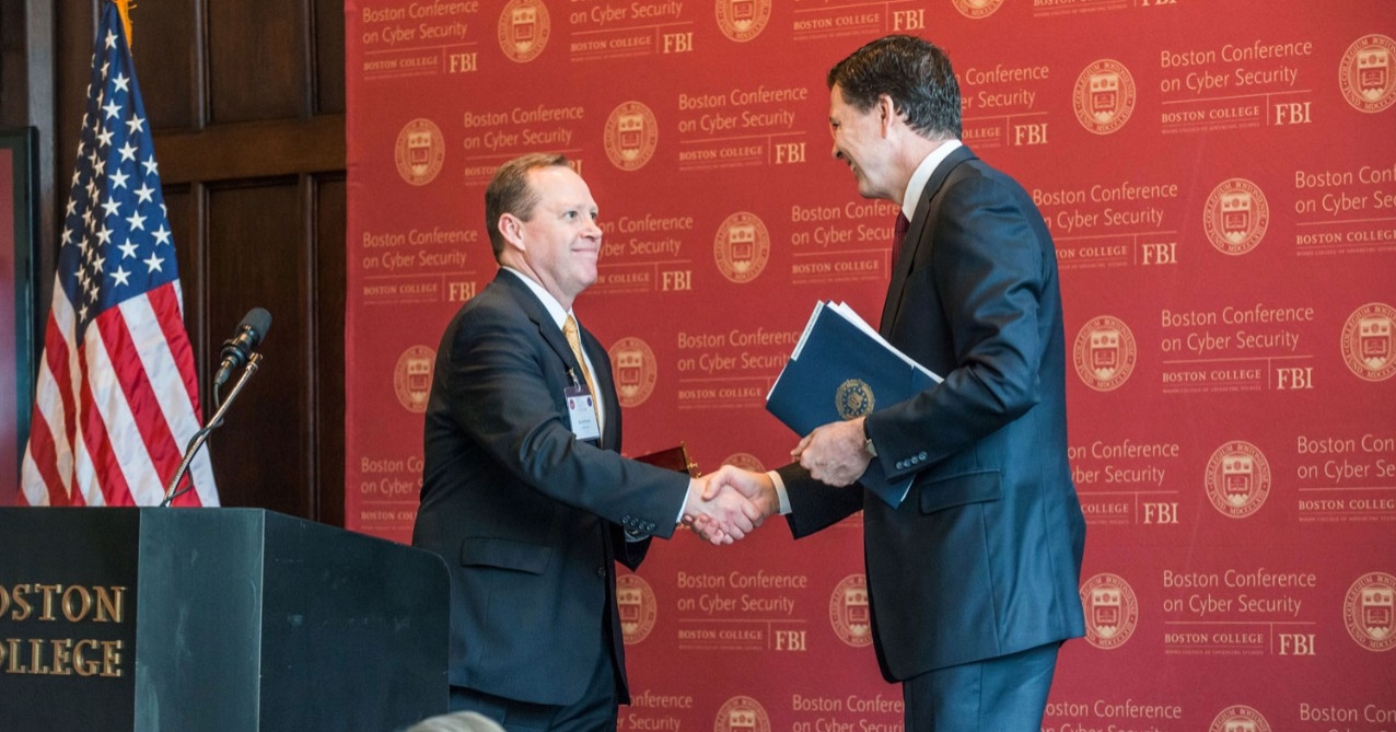 Conference organizer Kevin Powers, founding director of the Woods College Cybersecurity Policy & Governance program, with FBI Director Comey. Conference organizer Kevin Powers, founding director of the Woods College Cybersecurity Policy & Governance program, with FBI Director Comey.