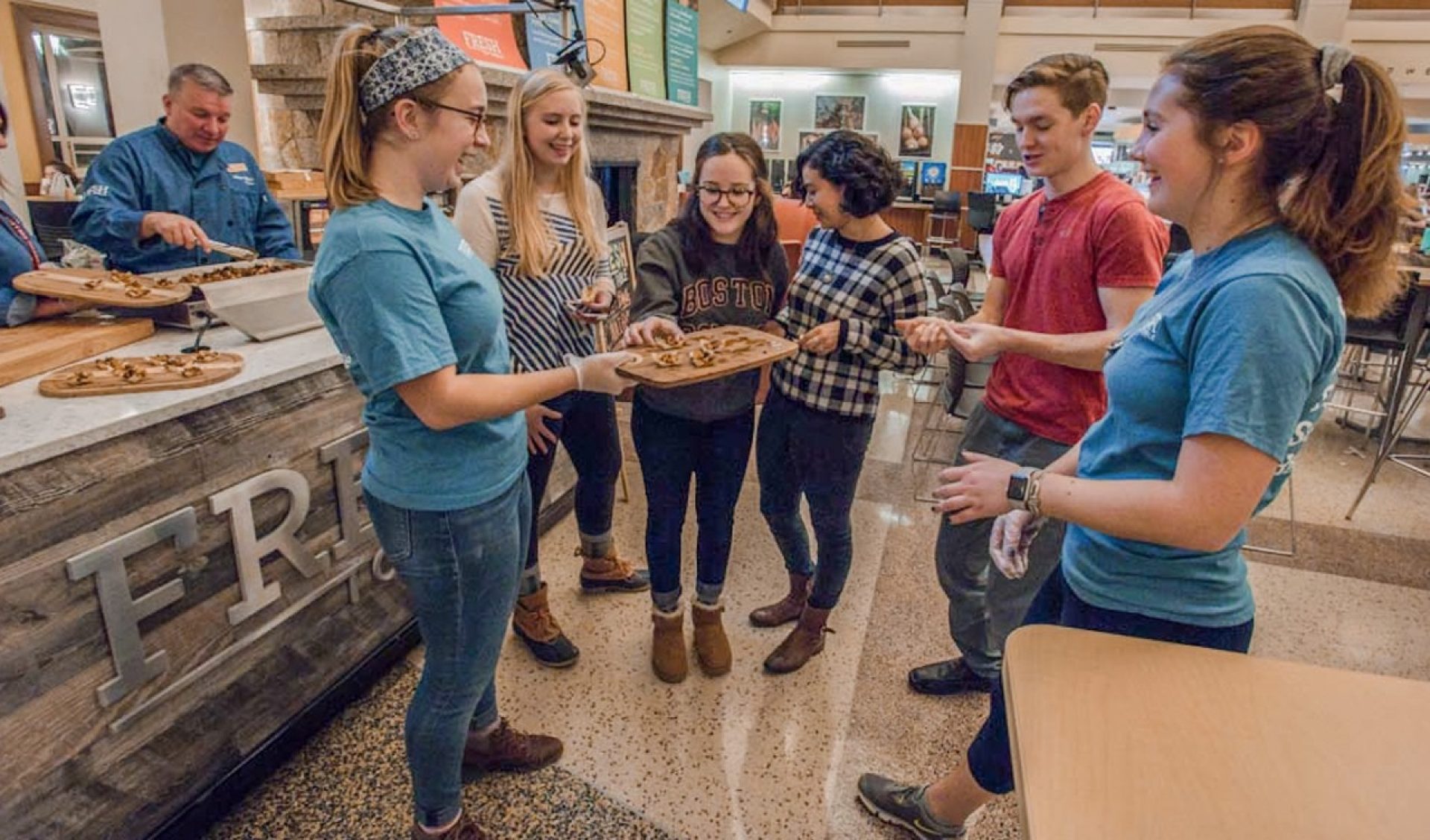 Students waiting for pasta meal being prepared