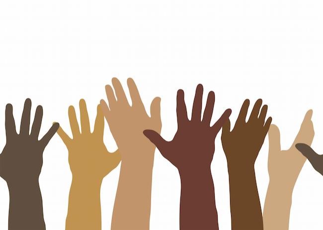 Image of raised hands in various skin colors
