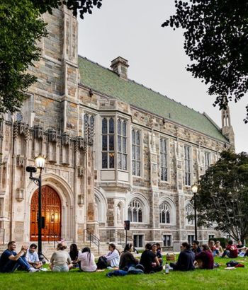 Students sitting outside of Burns Library