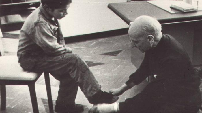 father pedro arrupe washing the feet of a boy