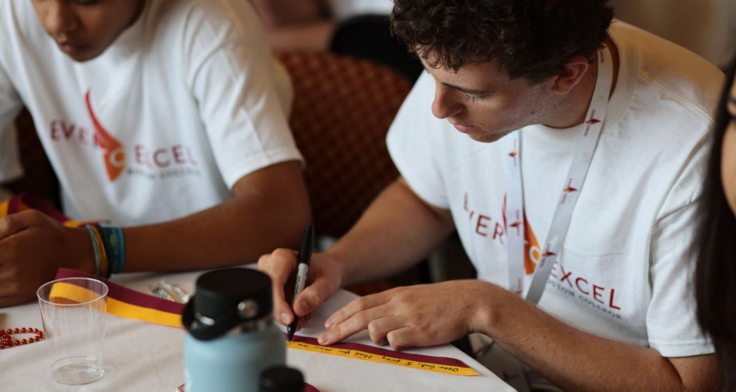 Ever to Excel Participant Fills Out a Boston College Prayer Ribbon