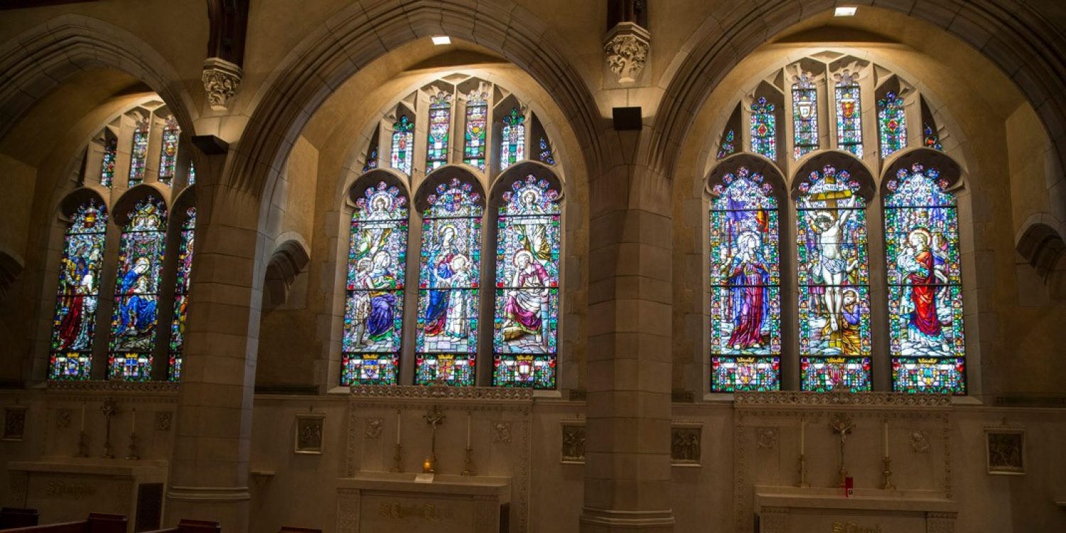 a wall with three large stained glass windows