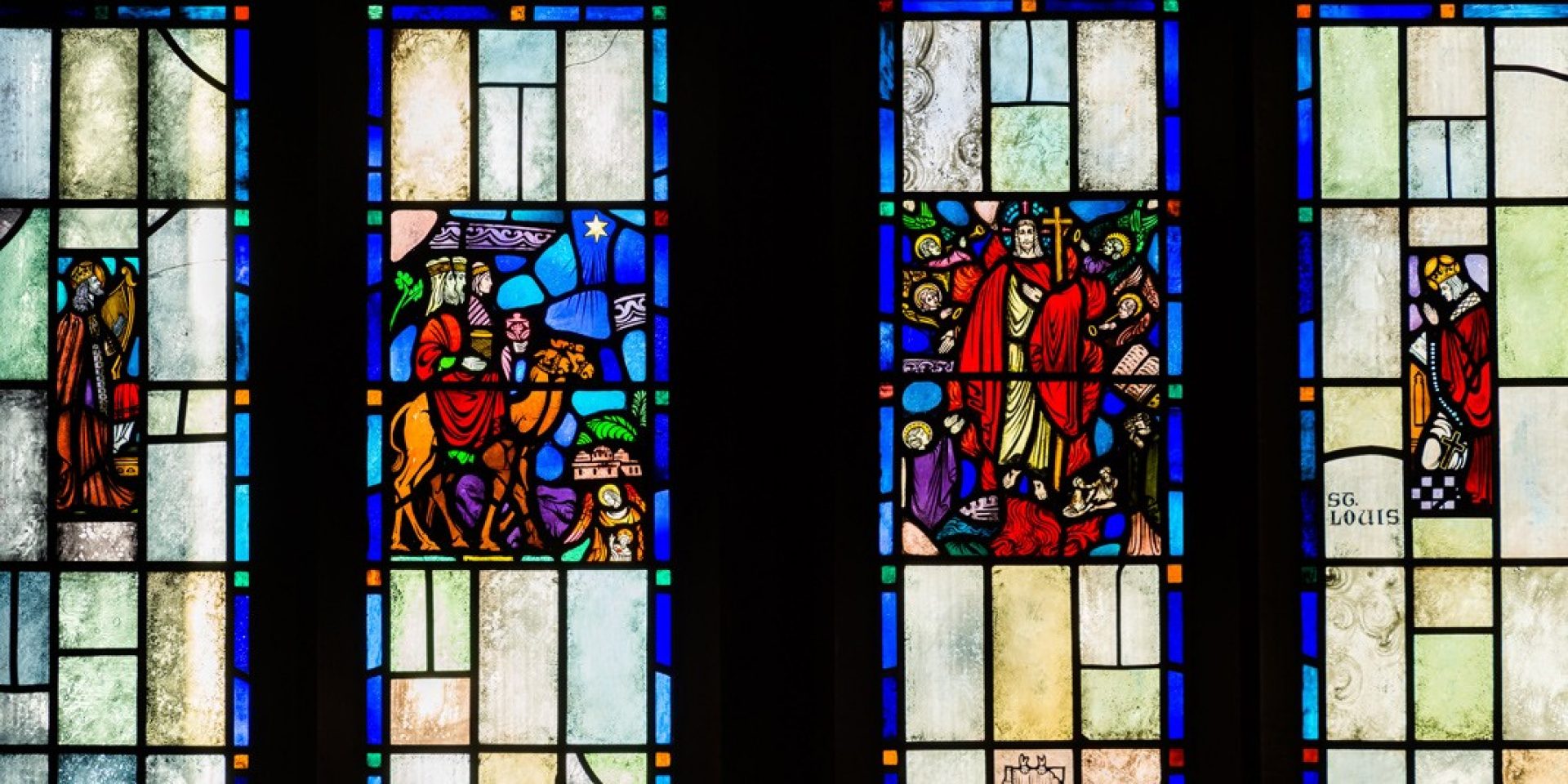 a wall with three large stained glass windows