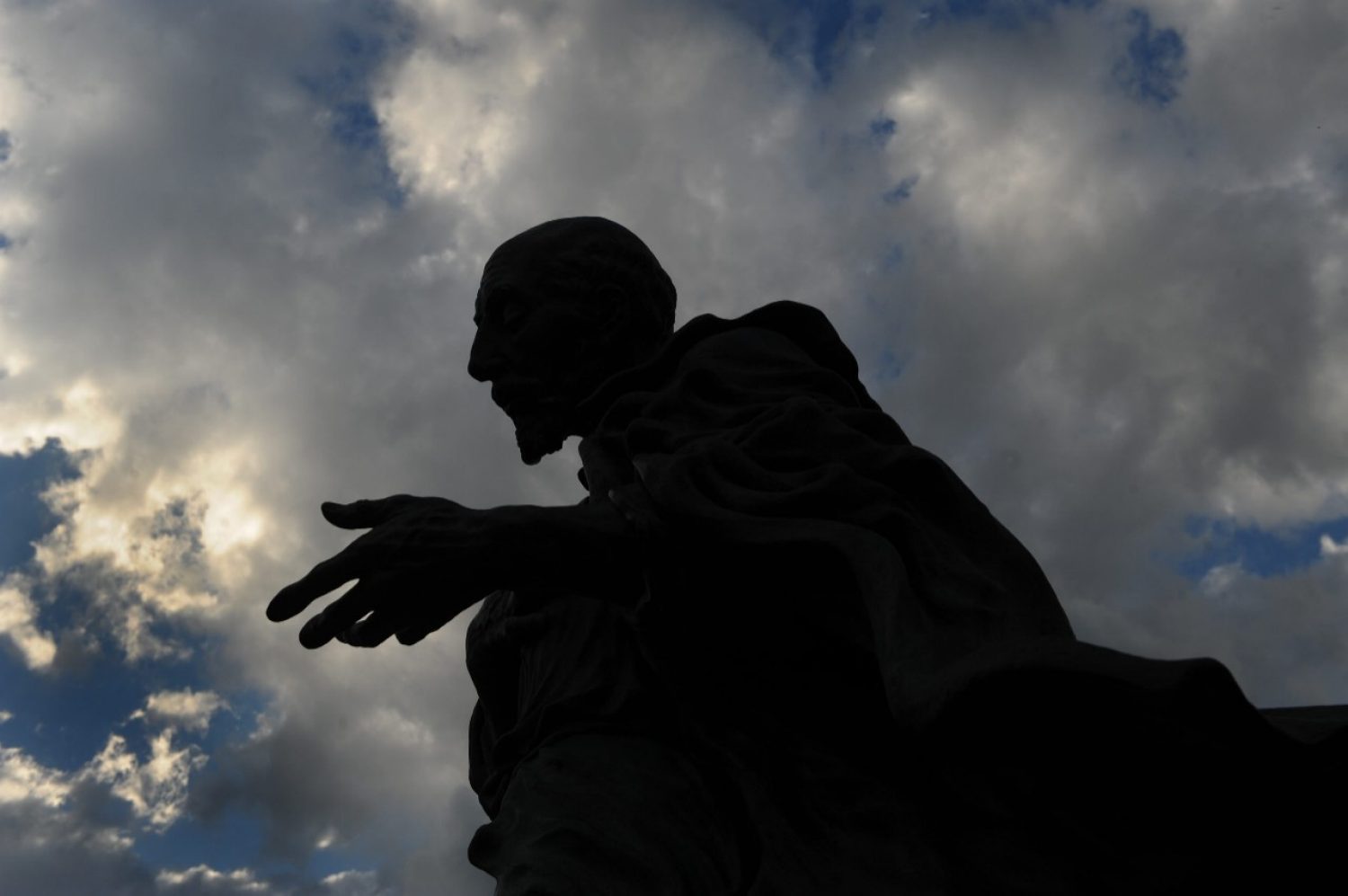 silhouette of the St. Ignatius statue with clouds in the background