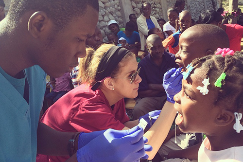 Students working with children on an international trip