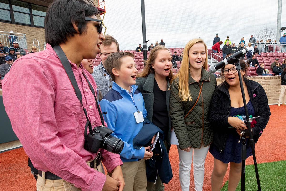 Attendees sing during the opening day ceremony.