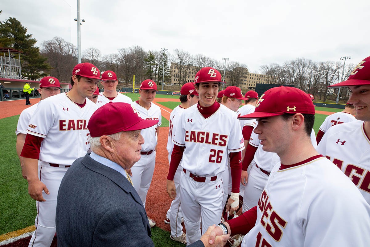 John Harrington speaking with BC Eagles players.