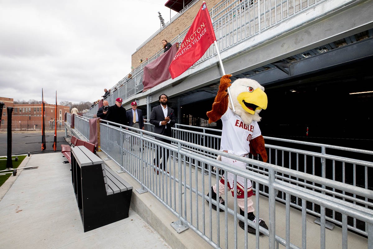 BC Eagles mascot walks with a flag.