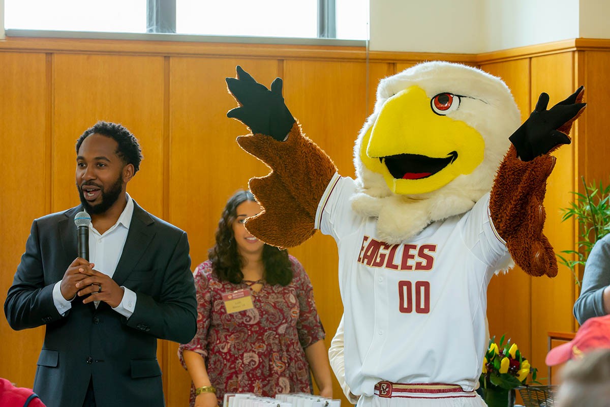 Eagles mascot raises arms in the air.