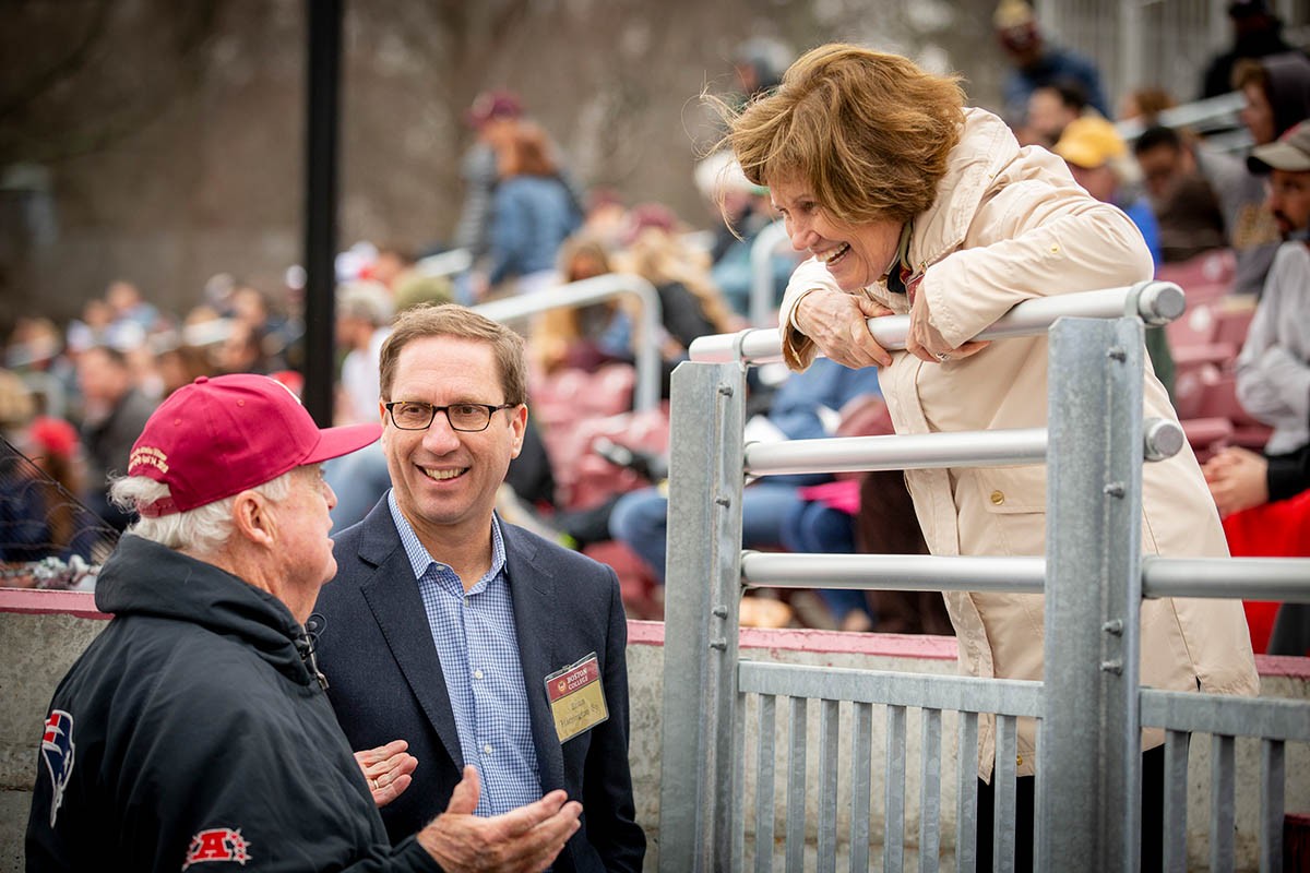 John Harrington speaking with a woman in the stands.