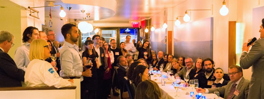 Nick Scandalios '87 speaking to a full room of people at an event in New York City.