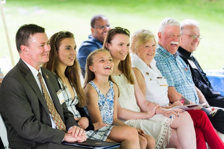 family sitting and smiling