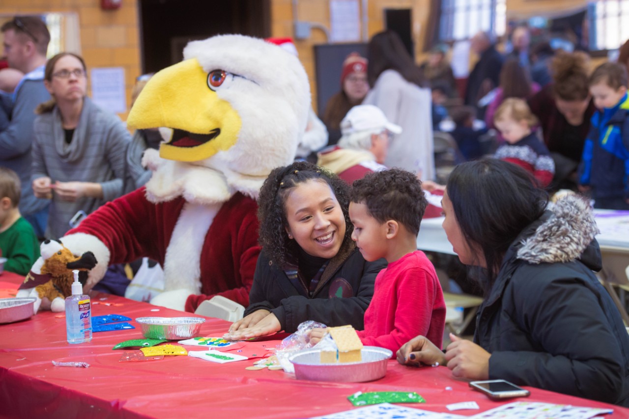 Young children and BC Mascot, Baldwin, doing arts and crafts
