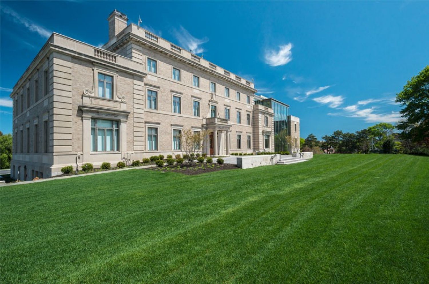 Exterior shot of 2101 with blue skies and green grass