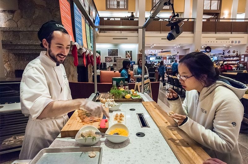 Student engaging with Dining Services employee