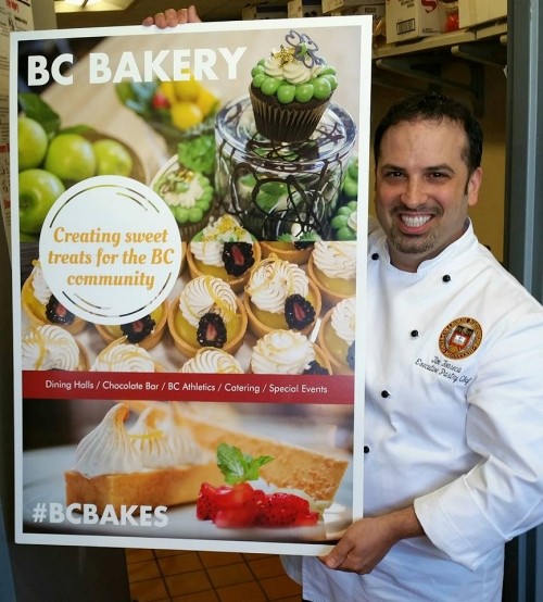 BC Bakery worker holding a sign