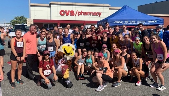 A group of people with the BC mascot