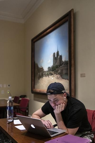 student sitting at laptop