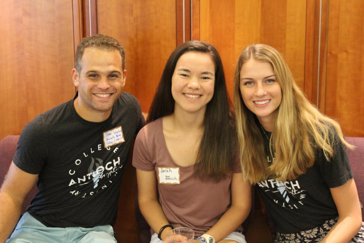 Three students smiling