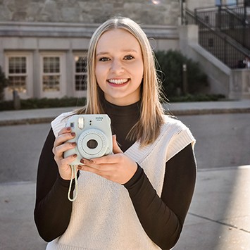 Laura holding camera