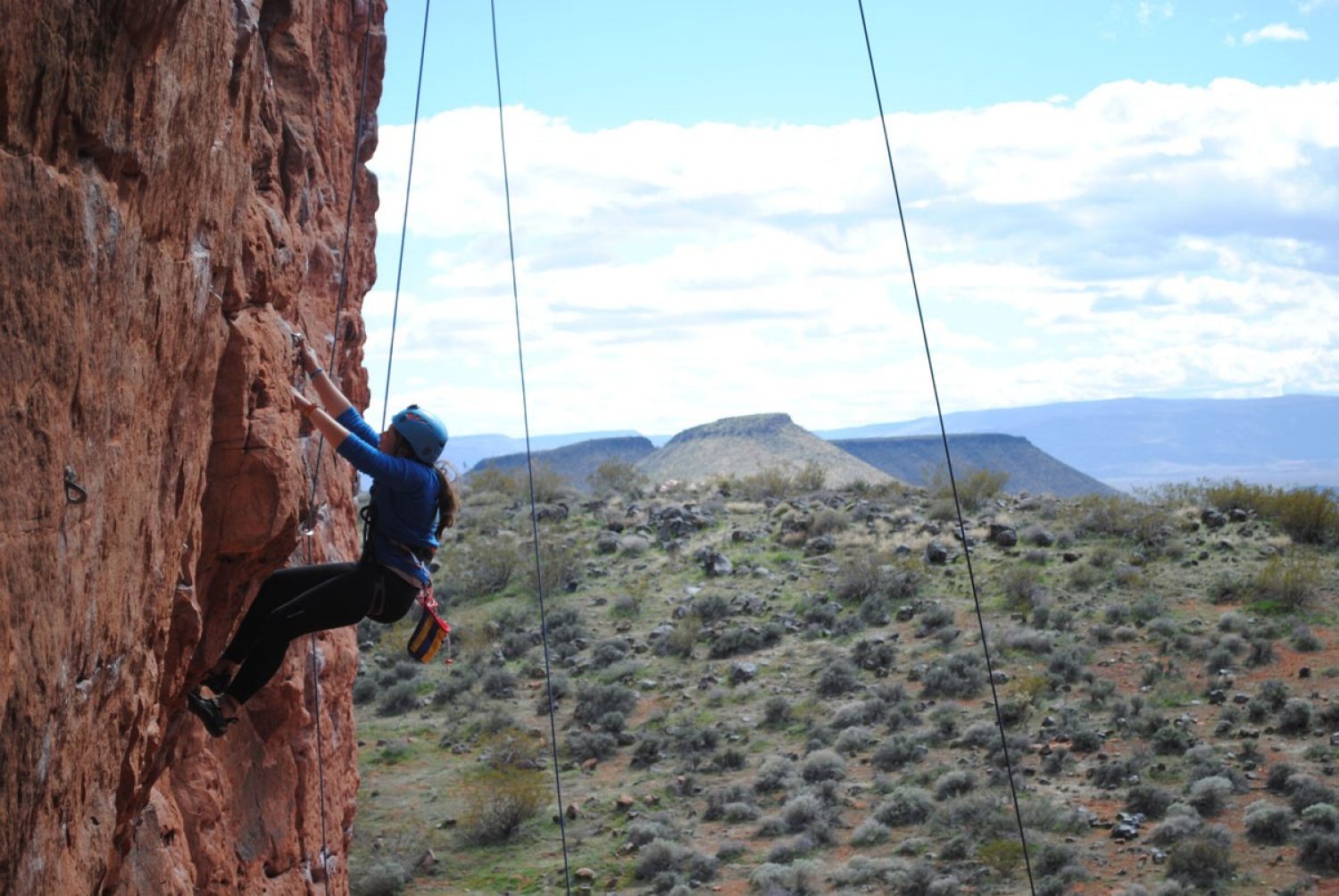 student climbing a rock face
