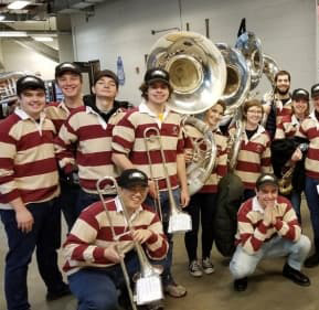A group of musicians wearing striped shirts
