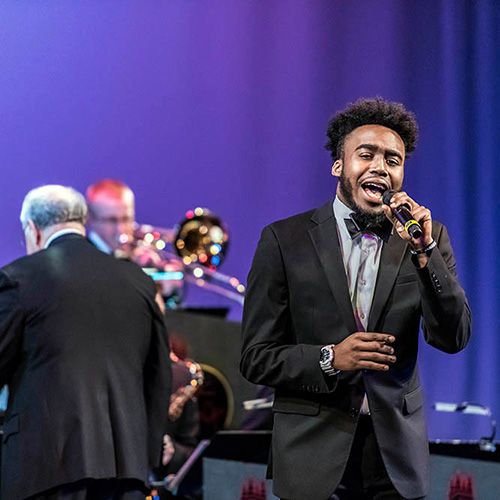 A person singing on stage