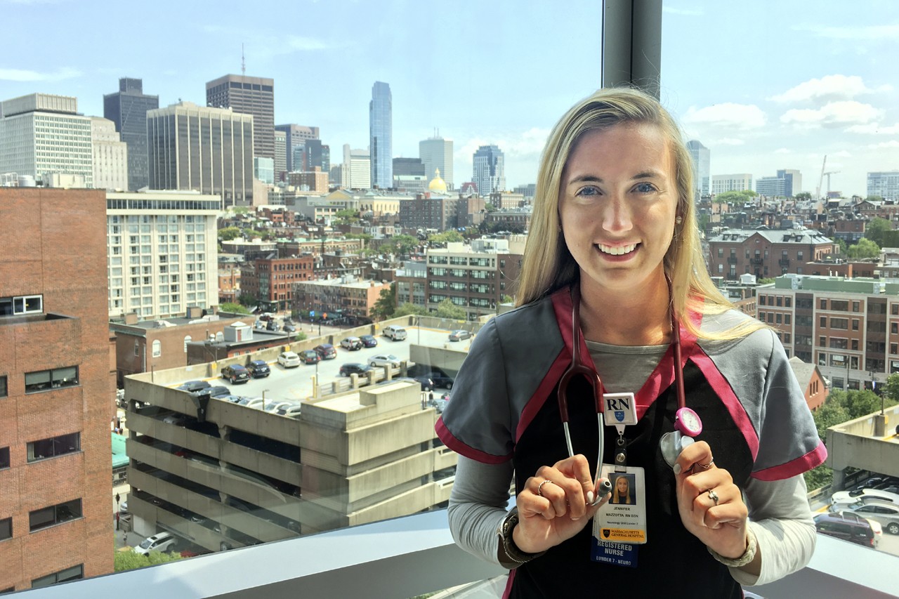 Nurse Jen Mazzotta standing in front of the Boston skyline