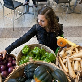 Student selecting vegetables at farmer's market at BC