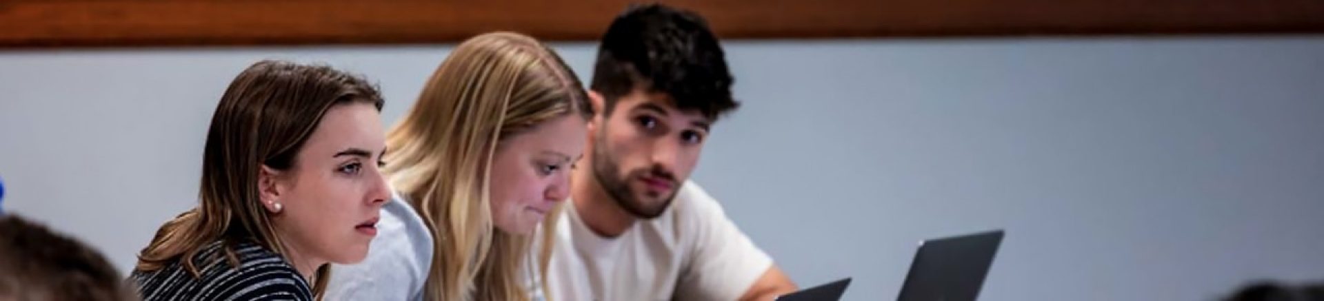 Three students sitting in class