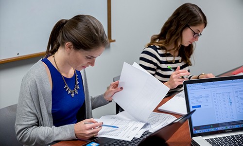 Graduate students reviewing company financials