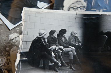 black and white photo of 4 women in a jail cell sitting on a bench