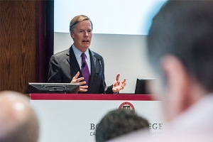Nicholas Burns ’78 speaking at a podium with audience members in the foreground