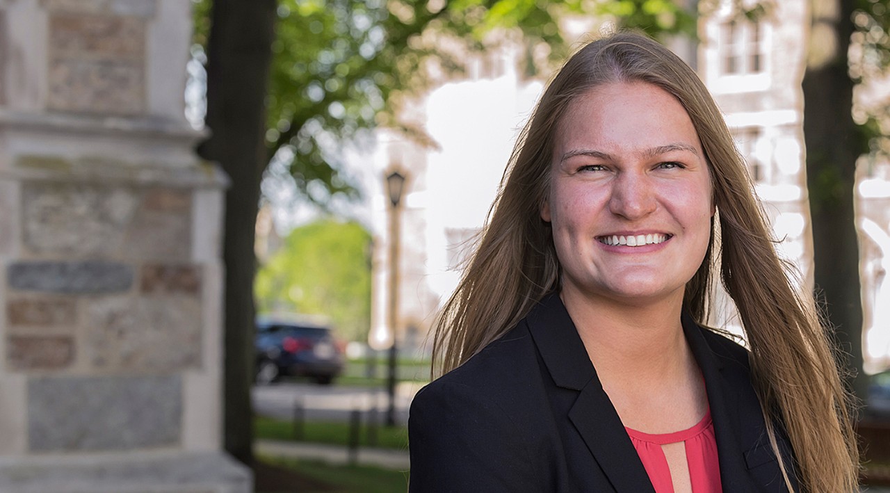 Lauren Wedell ’17, a young white woman in a blazer photographed in front of Fulton Hall